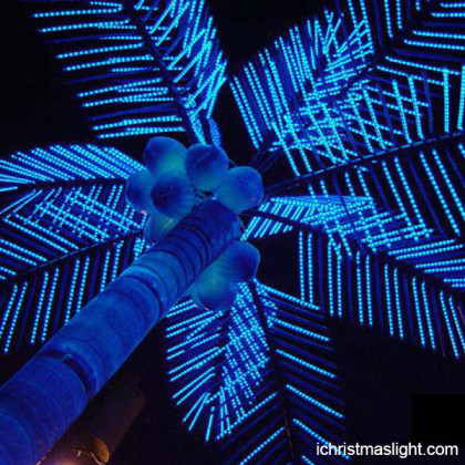 Outside blue LED lighted artificial palm tree