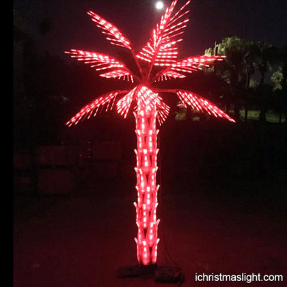 Outdoor red fake palm tree with lights