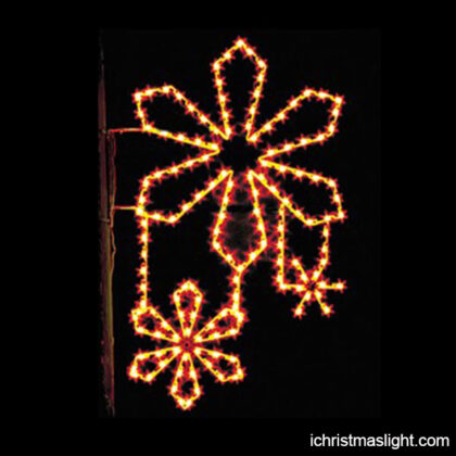 Outdoor lighted snowflakes for poles